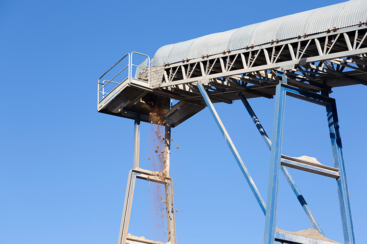 Outdoor conveyor system with corrugated metal cover